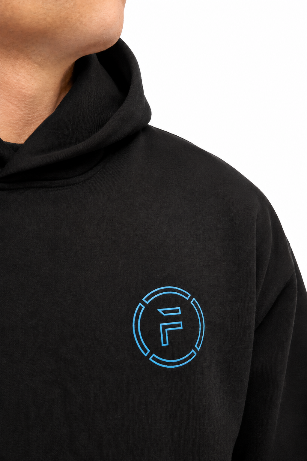 Close-up of a person wearing a black hoodie with a bright blue circular 'F' logo on the left chest, against a plain white background.