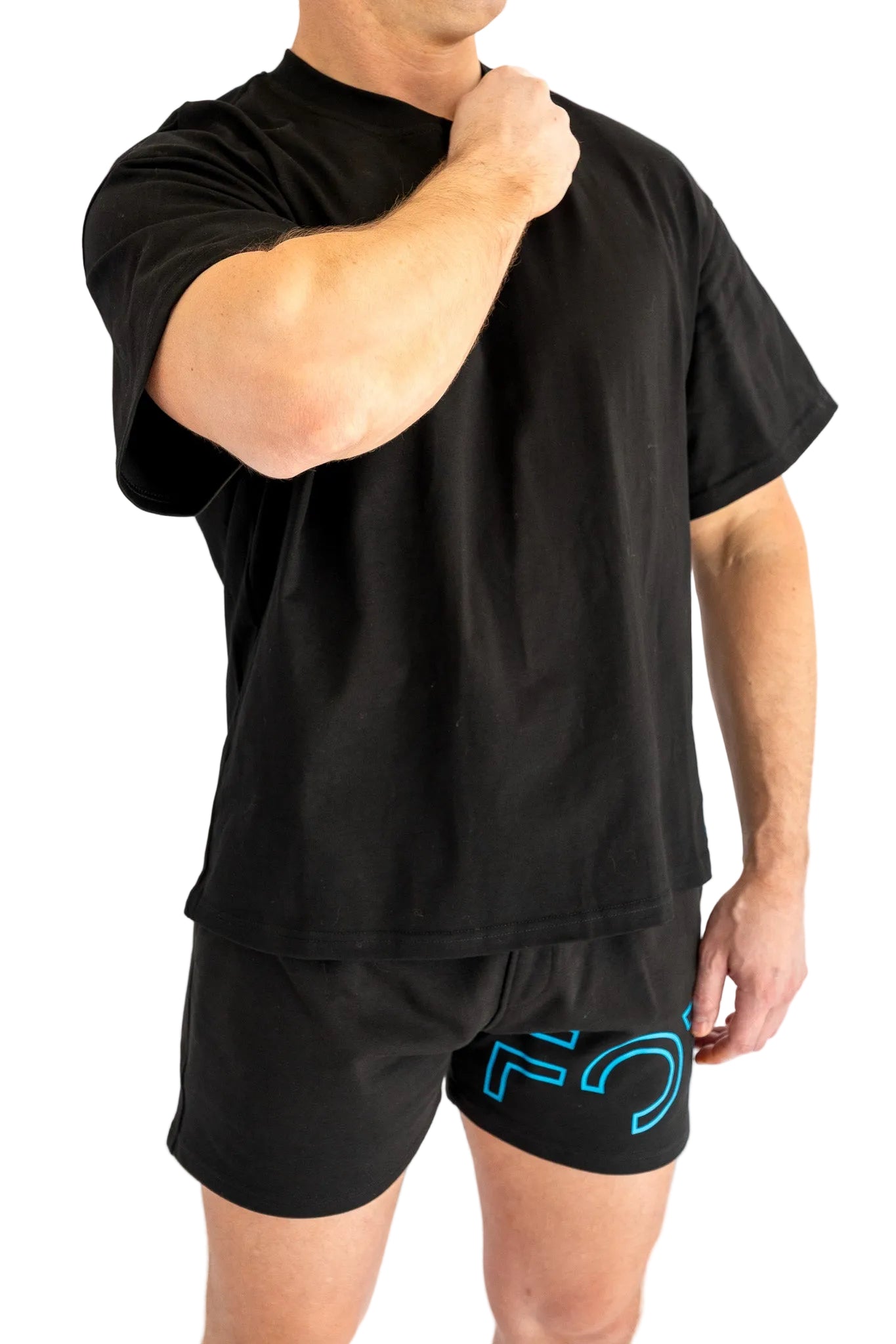 Person wearing a black t-shirt and shorts with a logo on a white background