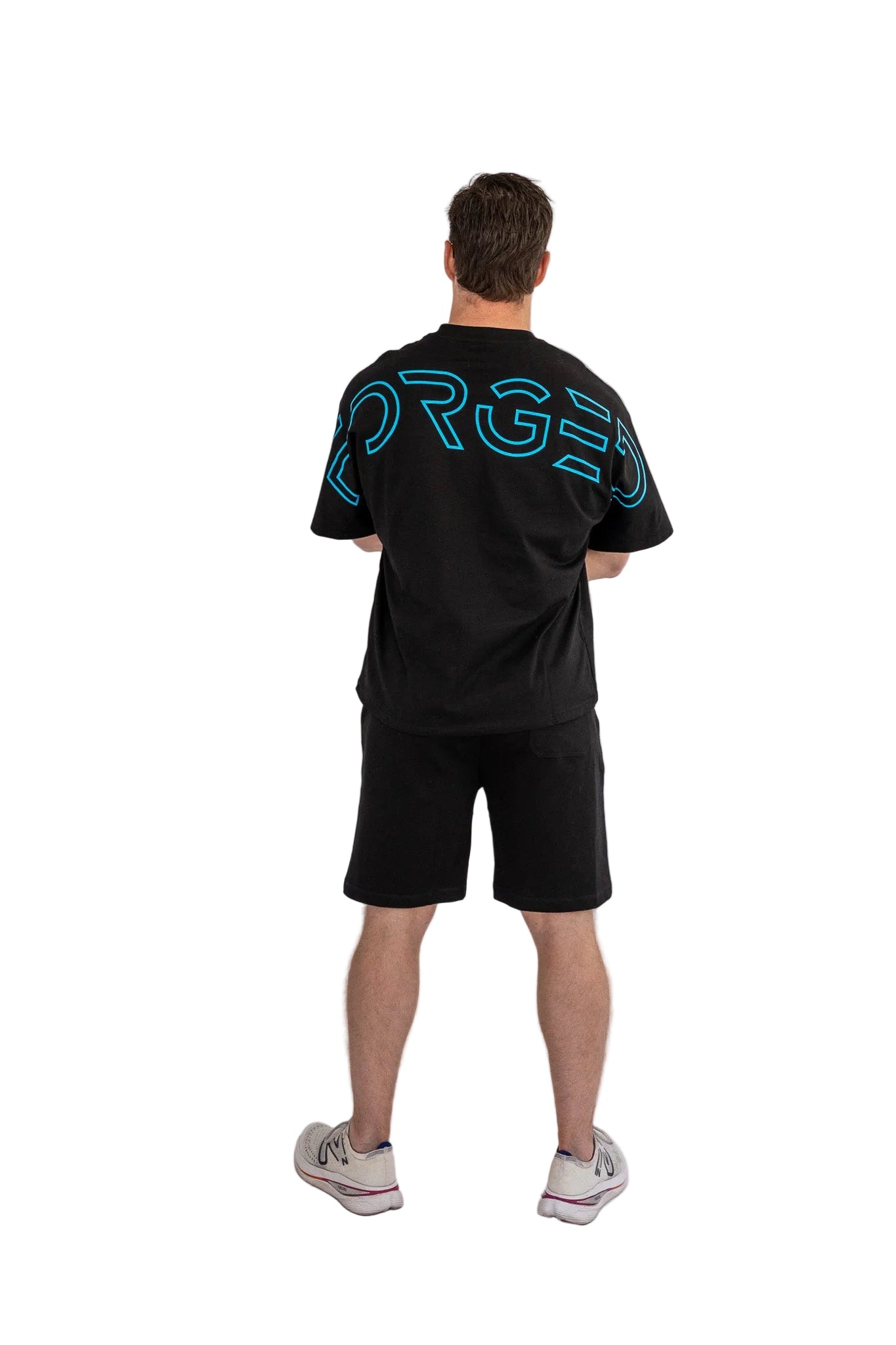 Person wearing a black t-shirt with blue text on the back against a white background
