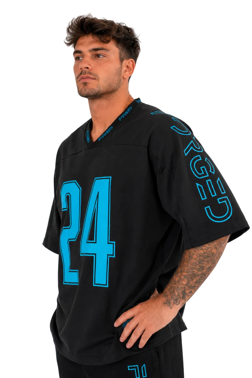 A man wearing a black athletic jersey with bright turquoise blue numbering and lettering, standing against a plain light gray background.