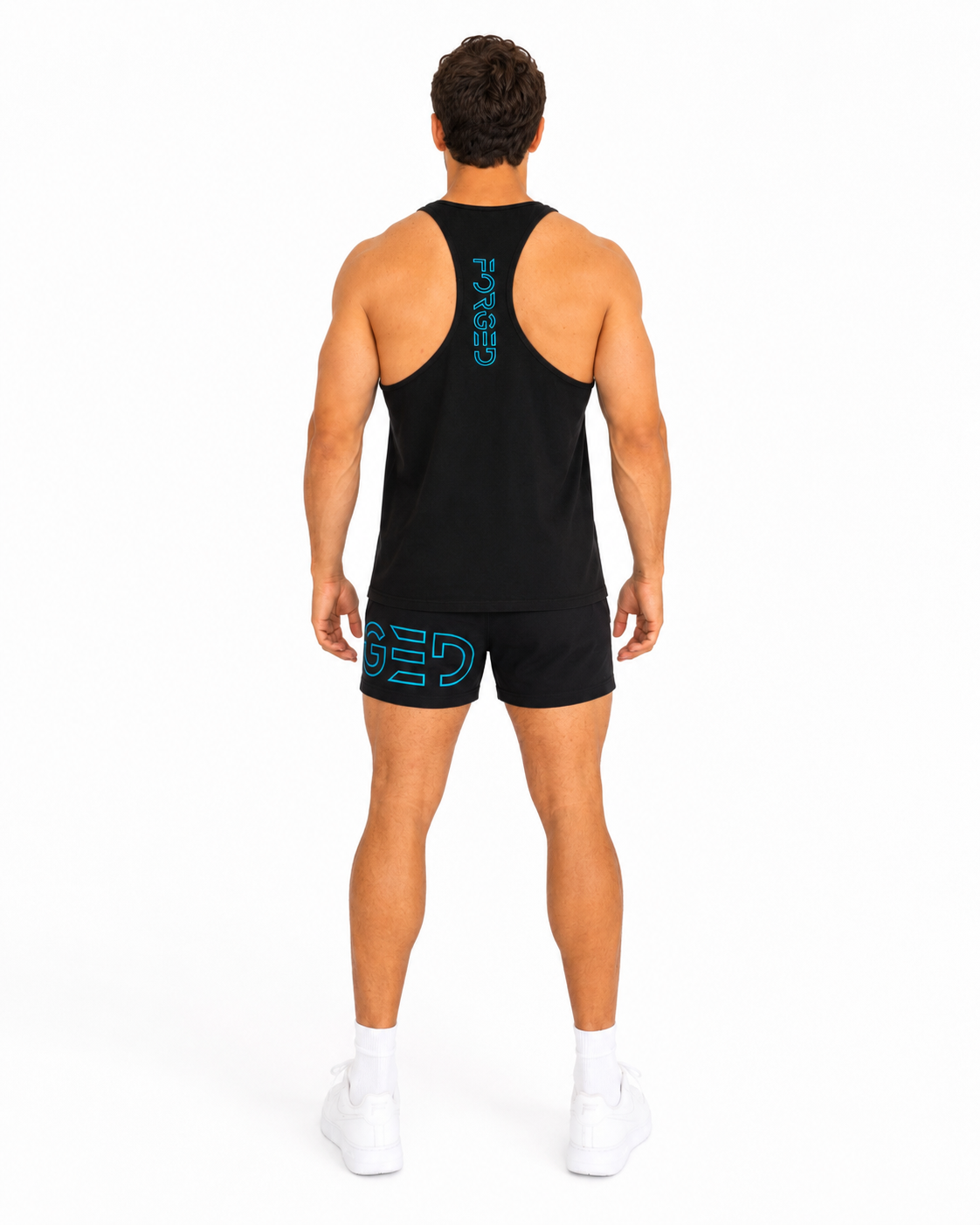 A man viewed from behind wearing a black athletic tank top and matching black shorts with bright blue-green logo accents, standing against a plain white studio background.